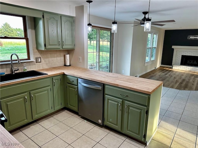 832 Meese Rd NE, Louisville, OH 44641 - kitchen with green cabinetry, dishwasher, a peninsula, and light tile patterned floors