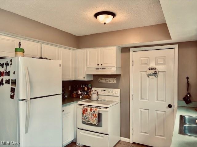 15539 Nantucket Cv # 3, Middlefield, OH 44062 - kitchen featuring white appliances, under cabinet range hood, white cabinetry, and a textured ceiling