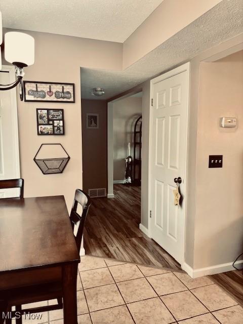 15539 Nantucket Cv # 3, Middlefield, OH 44062 - dining area with a textured ceiling and light tile patterned floors