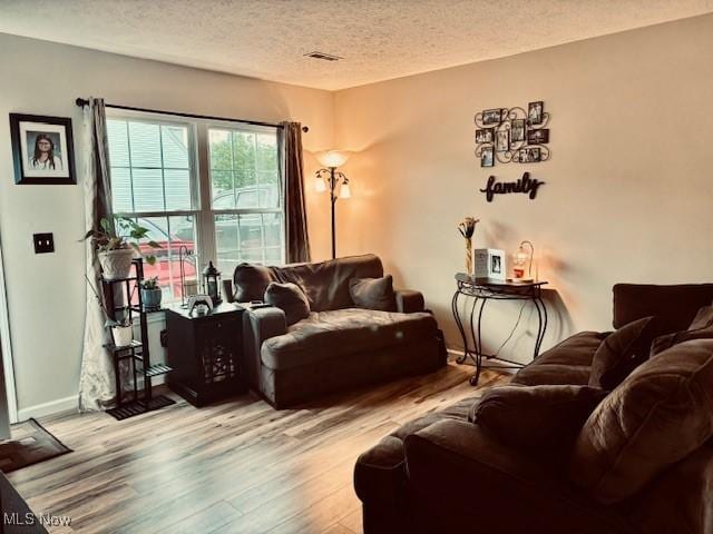 15539 Nantucket Cv # 3, Middlefield, OH 44062 - living room featuring wood finished floors and a textured ceiling