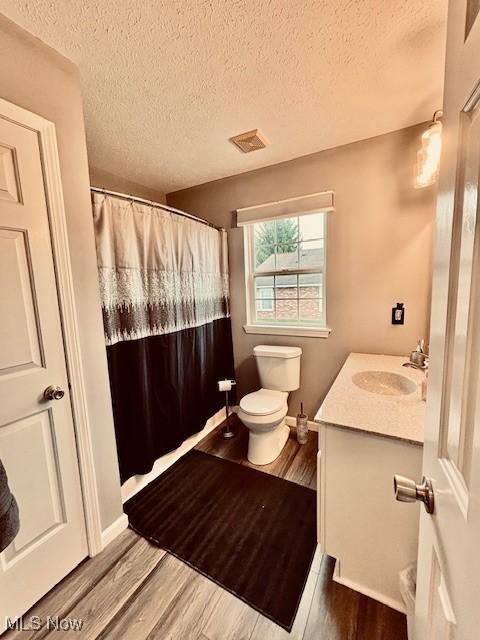 15539 Nantucket Cv # 3, Middlefield, OH 44062 - full bathroom with vanity, wood finished floors, a textured ceiling, and curtained shower