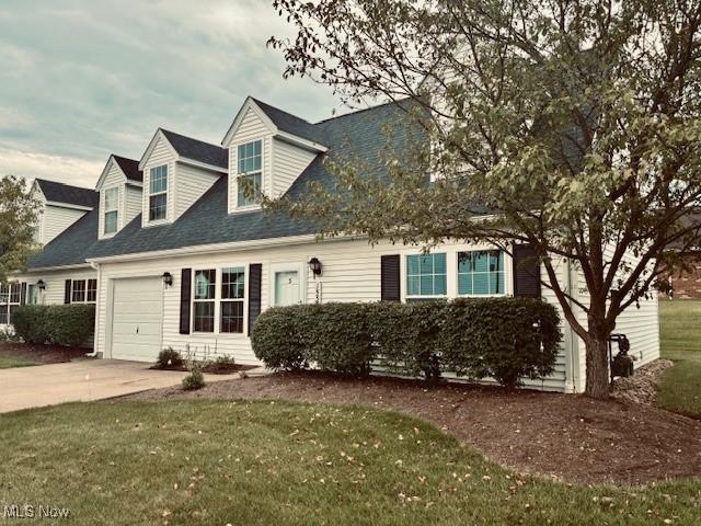 15539 Nantucket Cv # 3, Middlefield, OH 44062 - cape cod home featuring a garage, driveway, a front lawn, and roof with shingles