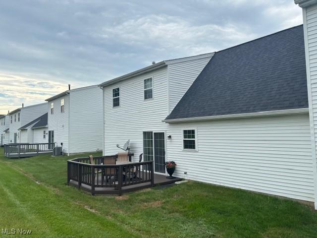 15539 Nantucket Cv # 3, Middlefield, OH 44062 - rear view of property with a wooden deck, a lawn, and roof with shingles