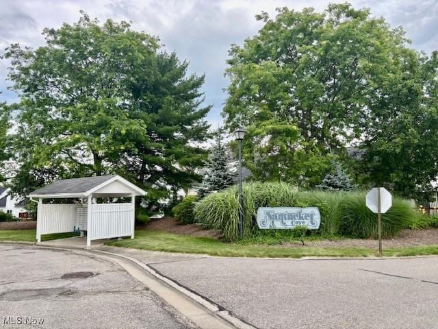 15539 Nantucket Cv # 3, Middlefield, OH 44062 - view of asphalt street with curbs, street lights, and traffic signs