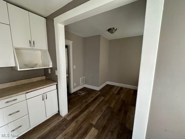 499 E 124th St, Cleveland, OH 44108 - kitchen with white cabinets, dark wood-style flooring, and light countertops