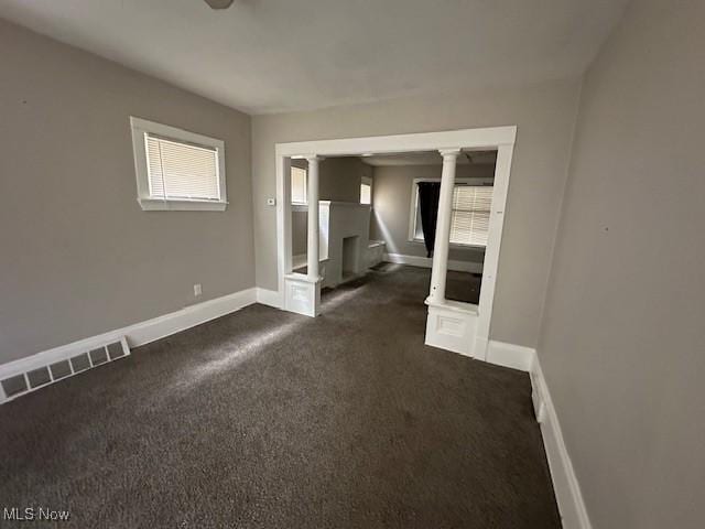 499 E 124th St, Cleveland, OH 44108 - empty room featuring decorative columns and dark colored carpet