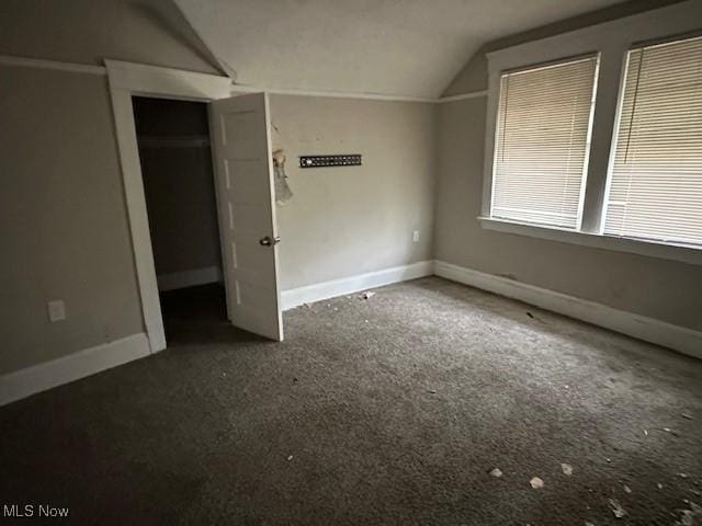 499 E 124th St, Cleveland, OH 44108 - unfurnished bedroom with lofted ceiling and carpet floors