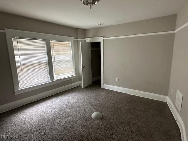 499 E 124th St, Cleveland, OH 44108 - unfurnished bedroom featuring dark colored carpet