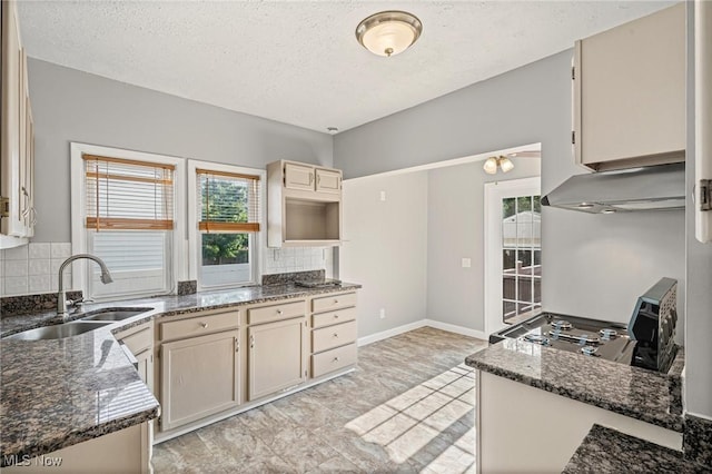 4305 W 49th St, Cleveland, OH 44144 - kitchen with exhaust hood, decorative backsplash, a textured ceiling, dark stone counters, and cream cabinets