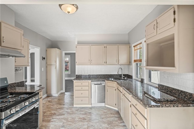 4305 W 49th St, Cleveland, OH 44144 - kitchen with stainless steel appliances, under cabinet range hood, cream cabinets, and tasteful backsplash