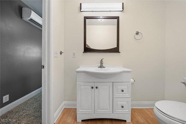 4305 W 49th St, Cleveland, OH 44144 - half bathroom with a wall unit AC, vanity, and wood finished floors