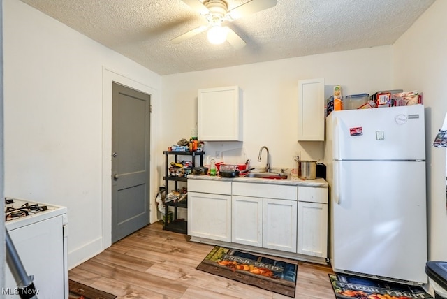 923 Lawton St, Akron, OH 44320 - kitchen featuring white appliances, a ceiling fan, white cabinetry, light wood-style floors, and a textured ceiling