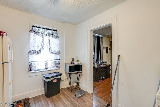 923 Lawton St, Akron, OH 44320 - dining room featuring light wood-type flooring and a textured ceiling