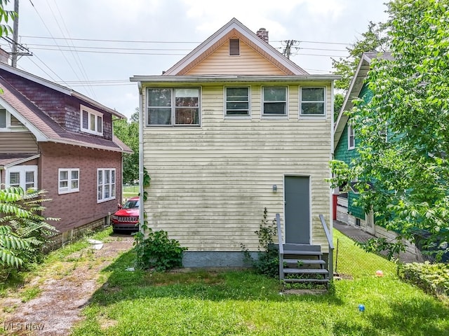 923 Lawton St, Akron, OH 44320 - rear view of property with a lawn, entry steps, and a chimney