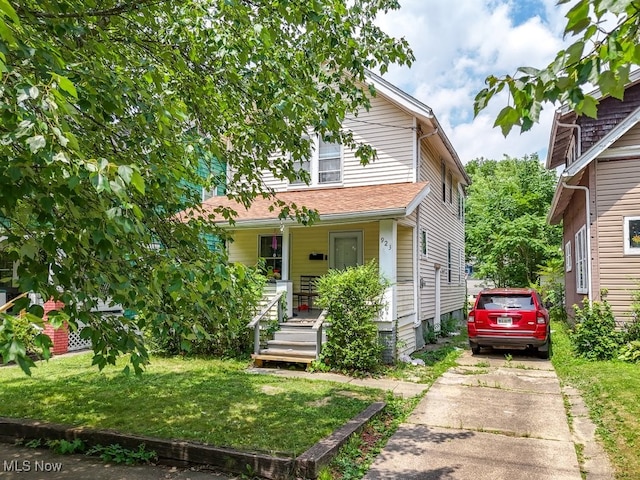 923 Lawton St, Akron, OH 44320 - view of front of house with concrete driveway, a porch, and a front lawn