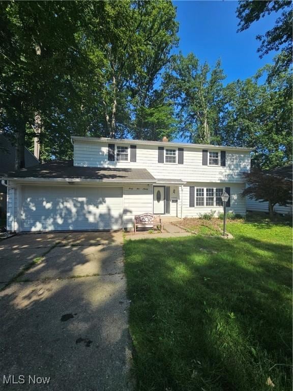 4590 Brendan Ln, North Olmsted, OH 44070 - view of front of home featuring driveway, a front lawn, and an attached garage