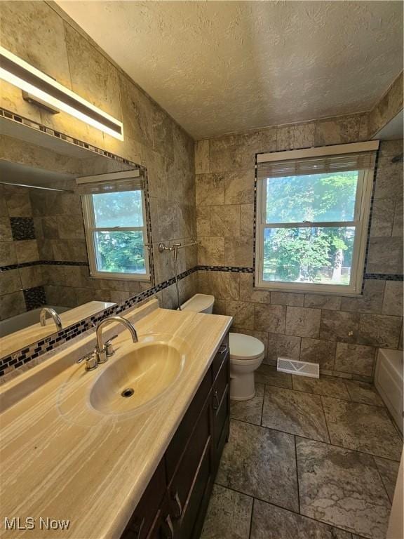 4590 Brendan Ln, North Olmsted, OH 44070 - bathroom featuring vanity, a textured ceiling, a shower, and a tub