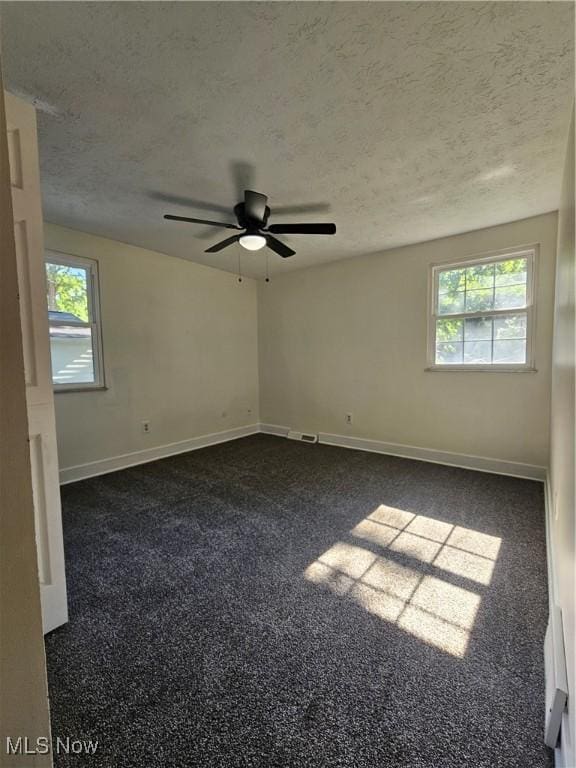 4590 Brendan Ln, North Olmsted, OH 44070 - spare room with a ceiling fan, dark colored carpet, and a textured ceiling