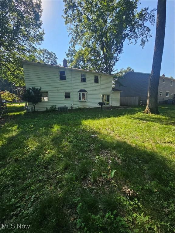 4590 Brendan Ln, North Olmsted, OH 44070 - back of house featuring a yard and a chimney