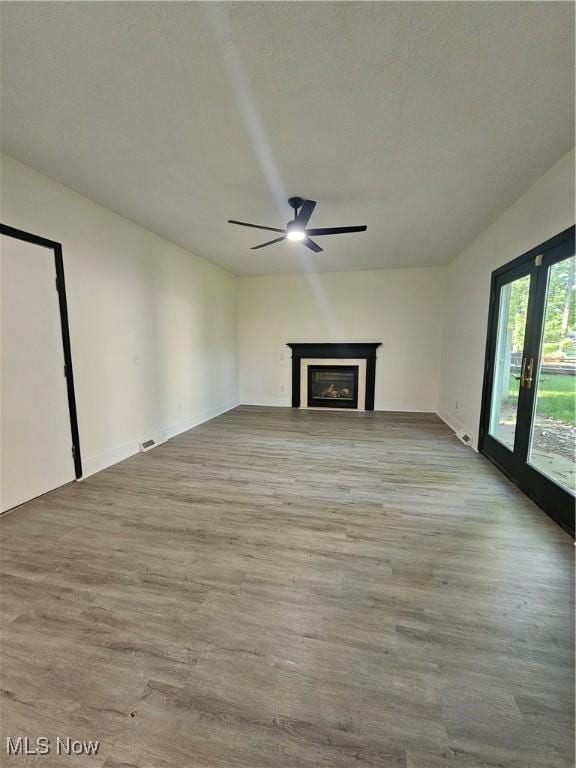 4590 Brendan Ln, North Olmsted, OH 44070 - unfurnished living room with a ceiling fan, wood finished floors, and a fireplace