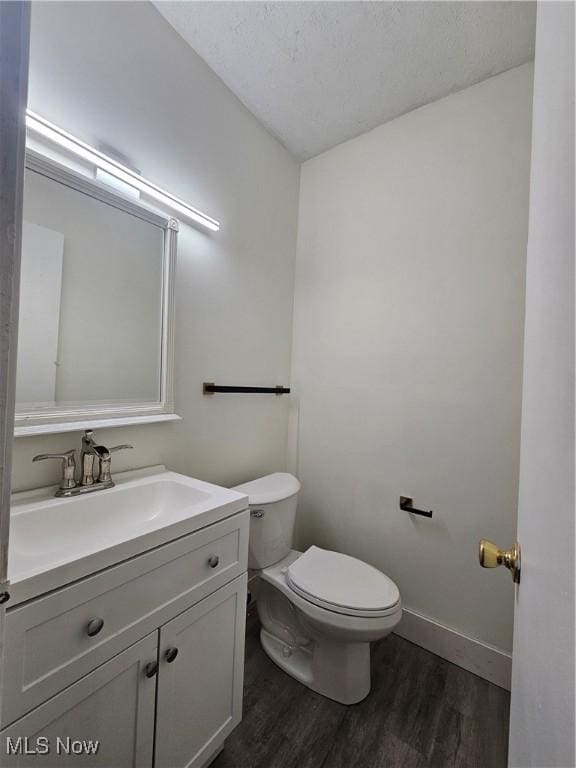 4590 Brendan Ln, North Olmsted, OH 44070 - half bath with wood finished floors, vanity, and a textured ceiling