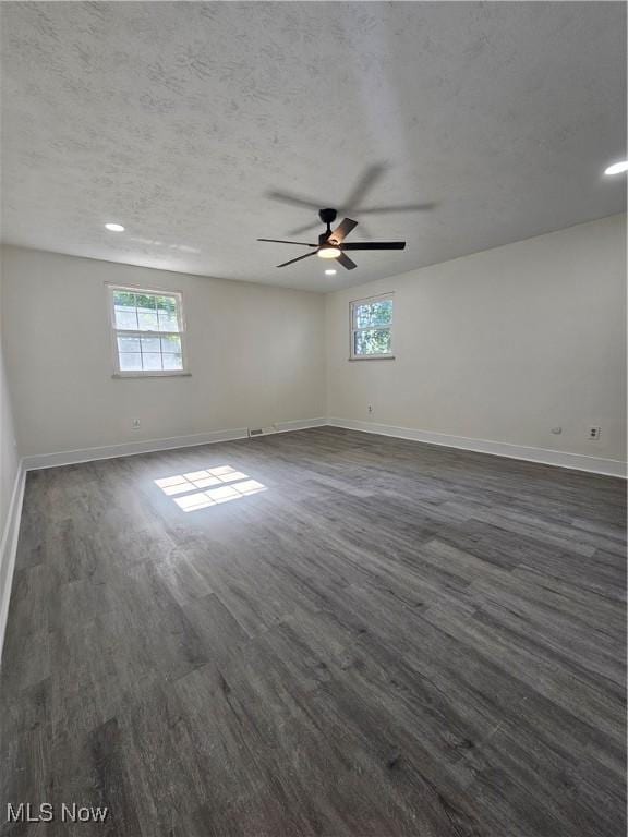 4590 Brendan Ln, North Olmsted, OH 44070 - empty room featuring healthy amount of natural light, dark wood finished floors, ceiling fan, a textured ceiling, and recessed lighting