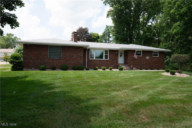 1074 S Meridian Rd, Austintown, OH 44509 - ranch-style house with a chimney, brick siding, and a front yard