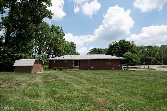 1074 S Meridian Rd, Austintown, OH 44509 - rear view of property with a storage shed, a yard, and brick siding