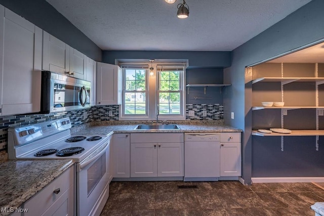 4412 14th Ave, Parkersburg, WV 26101 - kitchen featuring white appliances, a textured ceiling, open shelves, backsplash, and white cabinetry