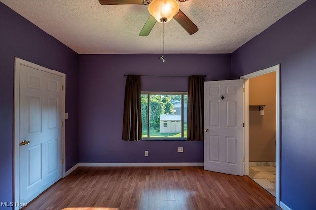 4412 14th Ave, Parkersburg, WV 26101 - unfurnished bedroom with wood finished floors, a textured ceiling, and ceiling fan