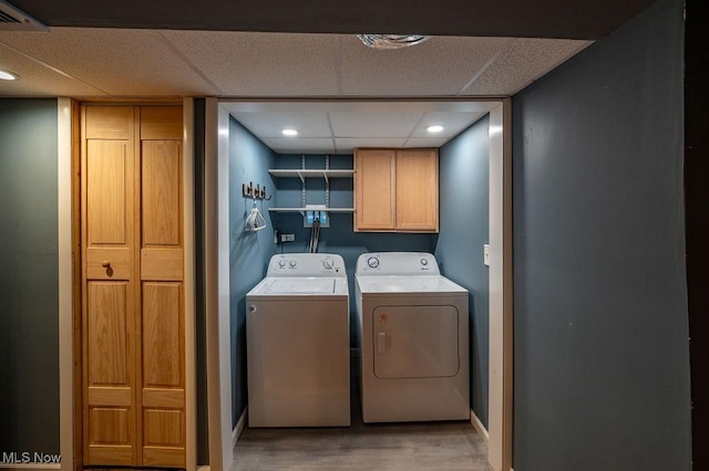 4412 14th Ave, Parkersburg, WV 26101 - laundry room featuring cabinet space, washer and dryer, and light wood-style flooring
