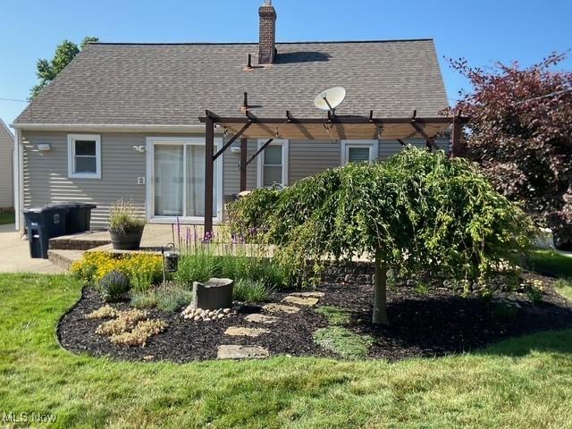 5384 Huron Rd, Lyndhurst, OH 44124 - back of house featuring a shingled roof, a chimney, a yard, a pergola, and a patio