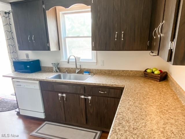 5384 Huron Rd, Lyndhurst, OH 44124 - kitchen with white dishwasher, light countertops, dark brown cabinets, and dark wood finished floors