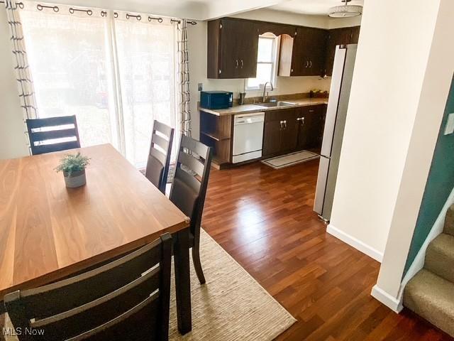 5384 Huron Rd, Lyndhurst, OH 44124 - dining room featuring dark wood-type flooring and stairs
