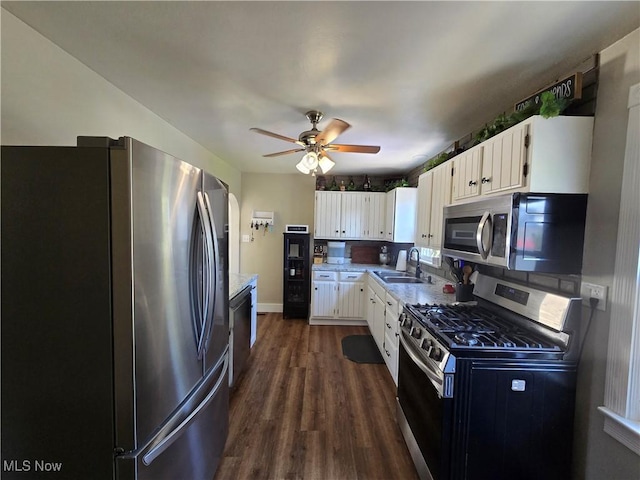 119 E 6th St, Williamstown, WV 26187 - kitchen featuring stainless steel appliances, dark wood-type flooring, white cabinetry, a ceiling fan, and light countertops