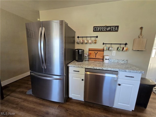 119 E 6th St, Williamstown, WV 26187 - kitchen featuring stainless steel appliances, dark wood-style floors, white cabinetry, and light stone counters