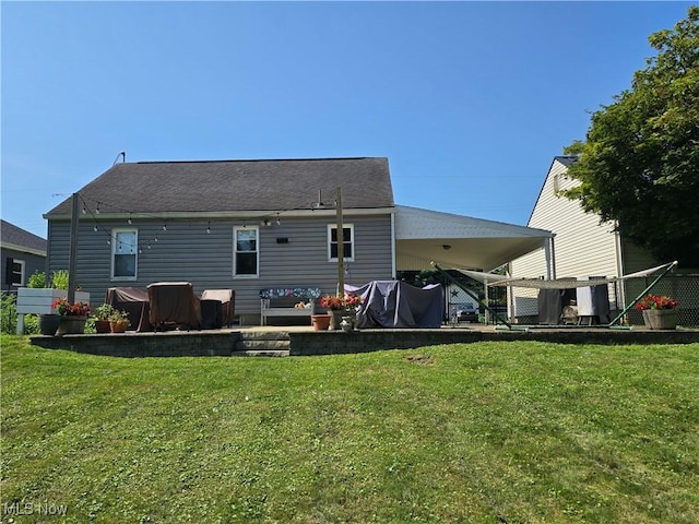 119 E 6th St, Williamstown, WV 26187 - back of property featuring a yard, a carport, and a patio area