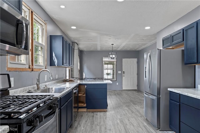 4010 11th Ave, Parkersburg, WV 26101 - kitchen featuring stainless steel appliances, light wood-style floors, plenty of natural light, blue cabinetry, and recessed lighting