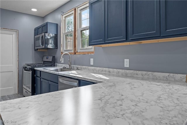 4010 11th Ave, Parkersburg, WV 26101 - kitchen with appliances with stainless steel finishes, blue cabinetry, and light countertops