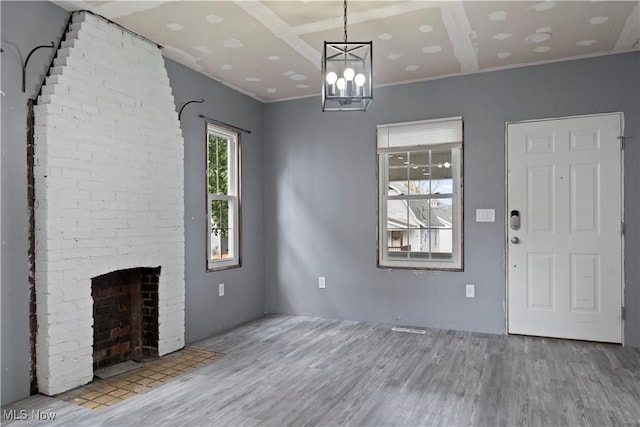 4010 11th Ave, Parkersburg, WV 26101 - unfurnished living room with wood finished floors, a brick fireplace, and crown molding