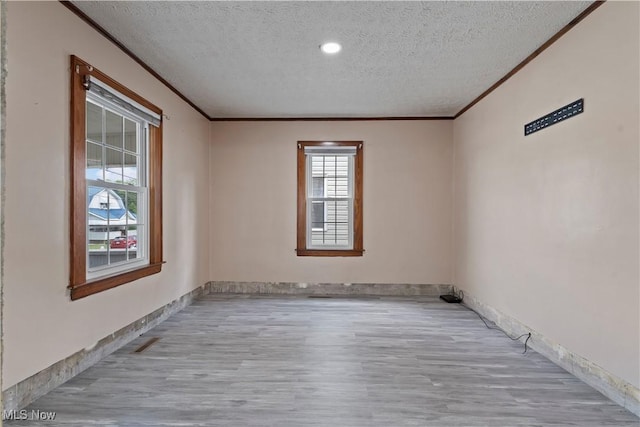 4010 11th Ave, Parkersburg, WV 26101 - unfurnished room featuring ornamental molding, a textured ceiling, and wood finished floors