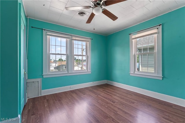 4010 11th Ave, Parkersburg, WV 26101 - unfurnished room featuring healthy amount of natural light, dark wood-style flooring, and a ceiling fan