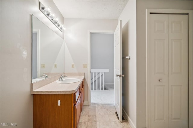 1653 Maple View Ct, Streetsboro, OH 44241 - bathroom with a closet, vanity, and a textured ceiling