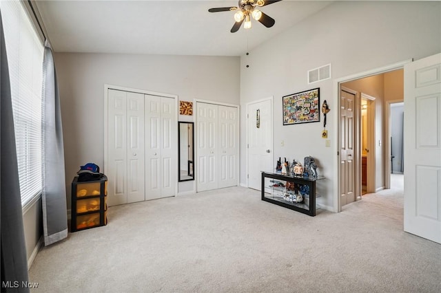 1653 Maple View Ct, Streetsboro, OH 44241 - carpeted bedroom with two closets, high vaulted ceiling, and ceiling fan