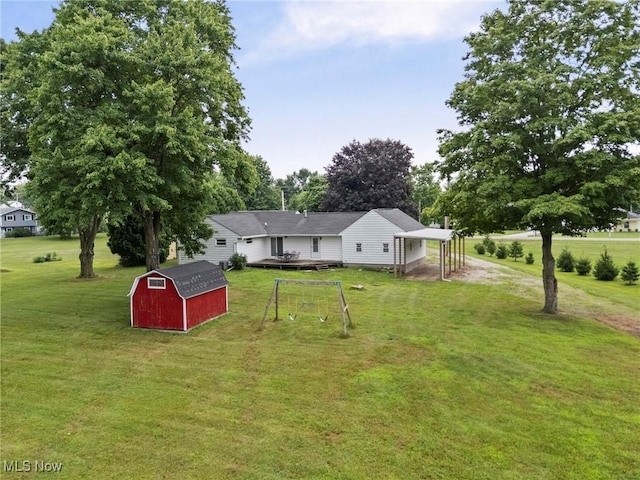 34 Prospect St, Seville, OH 44273 - back of property featuring a storage unit, a yard, and view of scattered trees