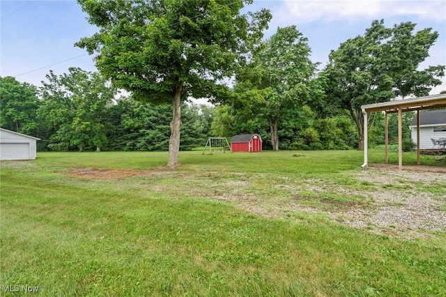 34 Prospect St, Seville, OH 44273 - view of green lawn featuring a shed and a garage