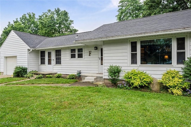 34 Prospect St, Seville, OH 44273 - single story home with an attached garage, a front yard, and a shingled roof