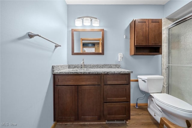 34 Prospect St, Seville, OH 44273 - full bathroom featuring wood finished floors, vanity, and a shower with shower door