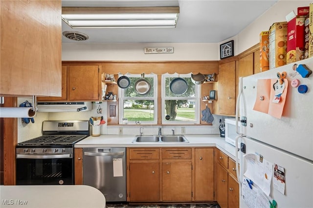 34 Prospect St, Seville, OH 44273 - kitchen featuring appliances with stainless steel finishes, under cabinet range hood, light countertops, and brown cabinets