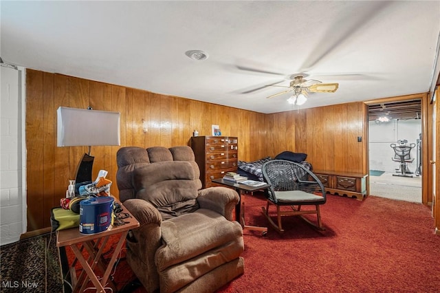 34 Prospect St, Seville, OH 44273 - living area featuring a ceiling fan, carpet flooring, and wooden walls